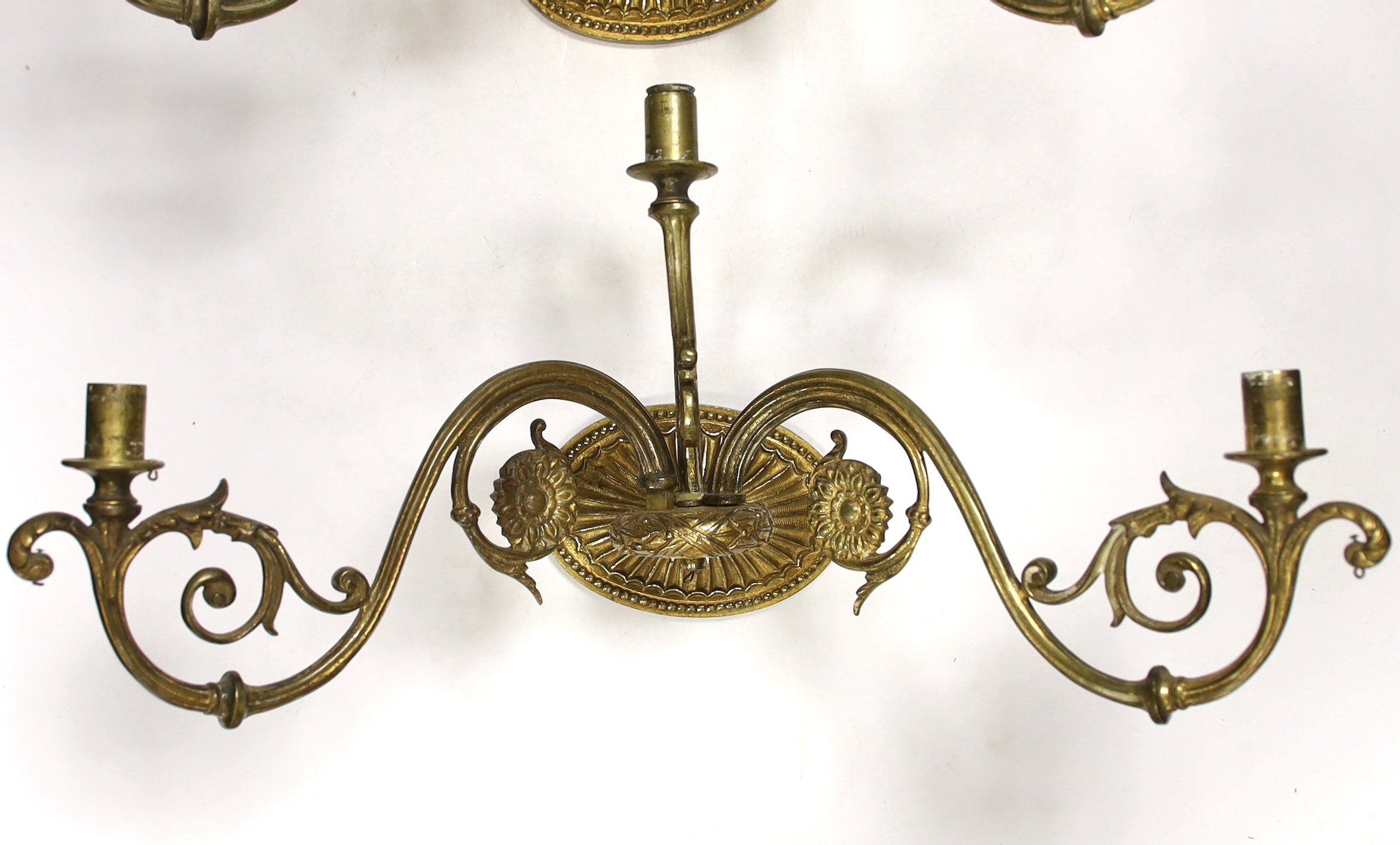 A pair of ornate brass three branch wall lights, 41cm wide